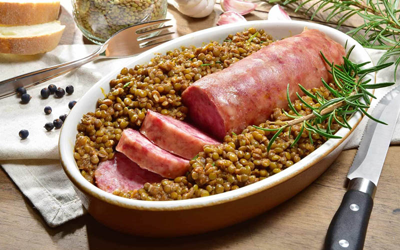 A hearty and aromatic bowl of Sausage and Lentils, showcasing the traditional Italian recipe filled with diverse vegetables and rich flavors.
