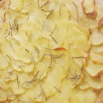 Pizza con Patate, a classic Italian pizza highlighting the delicate, creamy flavor of thinly sliced, crispy potatoes.