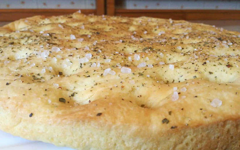 Focaccia Genovese, a cherished Italian bread known for its crispy exterior and soft interior
